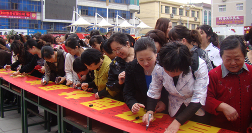 鎮(zhèn)安婦女在創(chuàng)建省級園林縣城橫幅上簽名